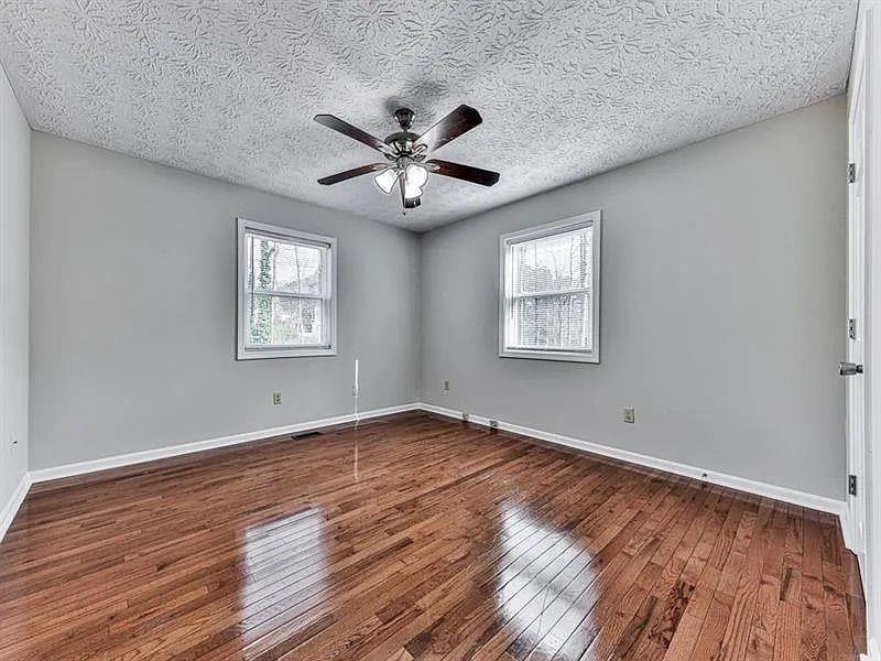 1400 Boxwood Trace Northwest Acworth, GA 30102 - Photo 13 of 23 a view of an empty room with a window and wooden floor