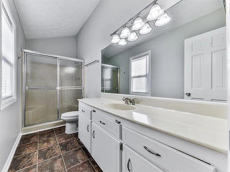 1400 Boxwood Trace Northwest Acworth, GA 30102 - Photo 14 of 23 a bathroom with a sink a toilet a mirror and shower