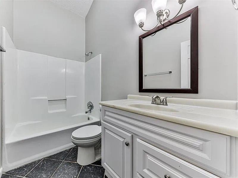 1400 Boxwood Trace Northwest Acworth, GA 30102 - Photo 16 of 23 a bathroom with a toilet a sink and a mirror