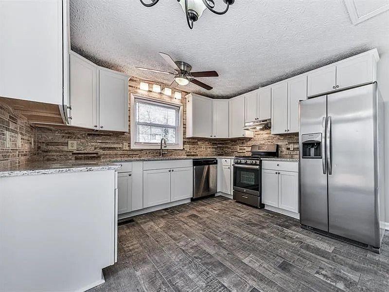 1400 Boxwood Trace Northwest Acworth, GA 30102 - Photo 10 of 23 a kitchen with white cabinets stainless steel appliances and window