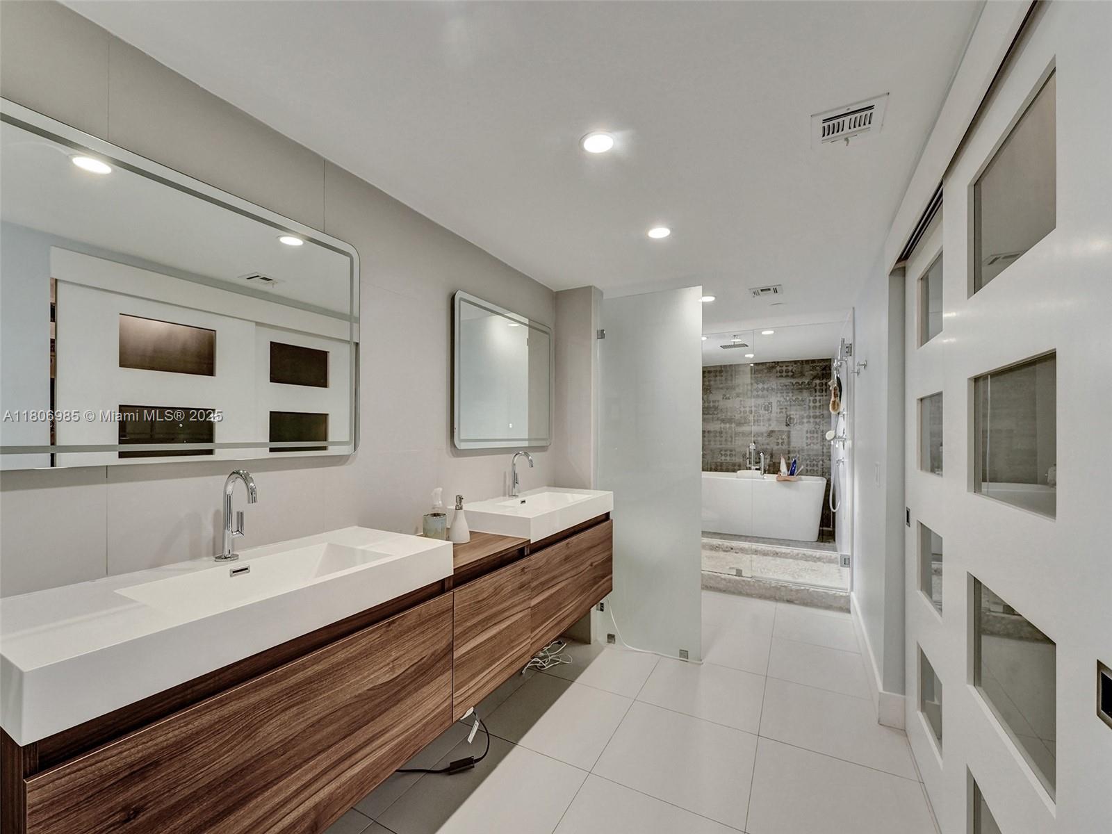 3638 Southwest 57th Avenue Miami, FL 33155 - Photo 23 of 43 a spacious bathroom with a double vanity sink a mirror and shower