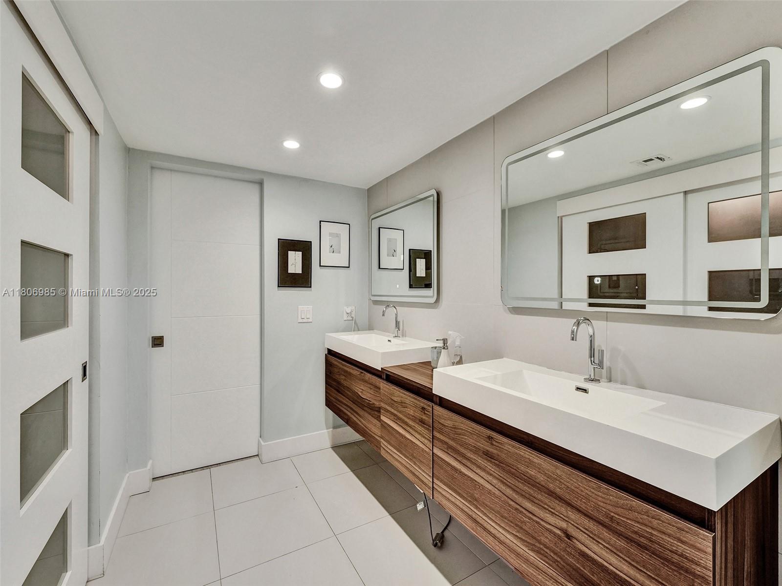 3638 Southwest 57th Avenue Miami, FL 33155 - Photo 24 of 43 a en suite bathroom with double vanity and a mirror