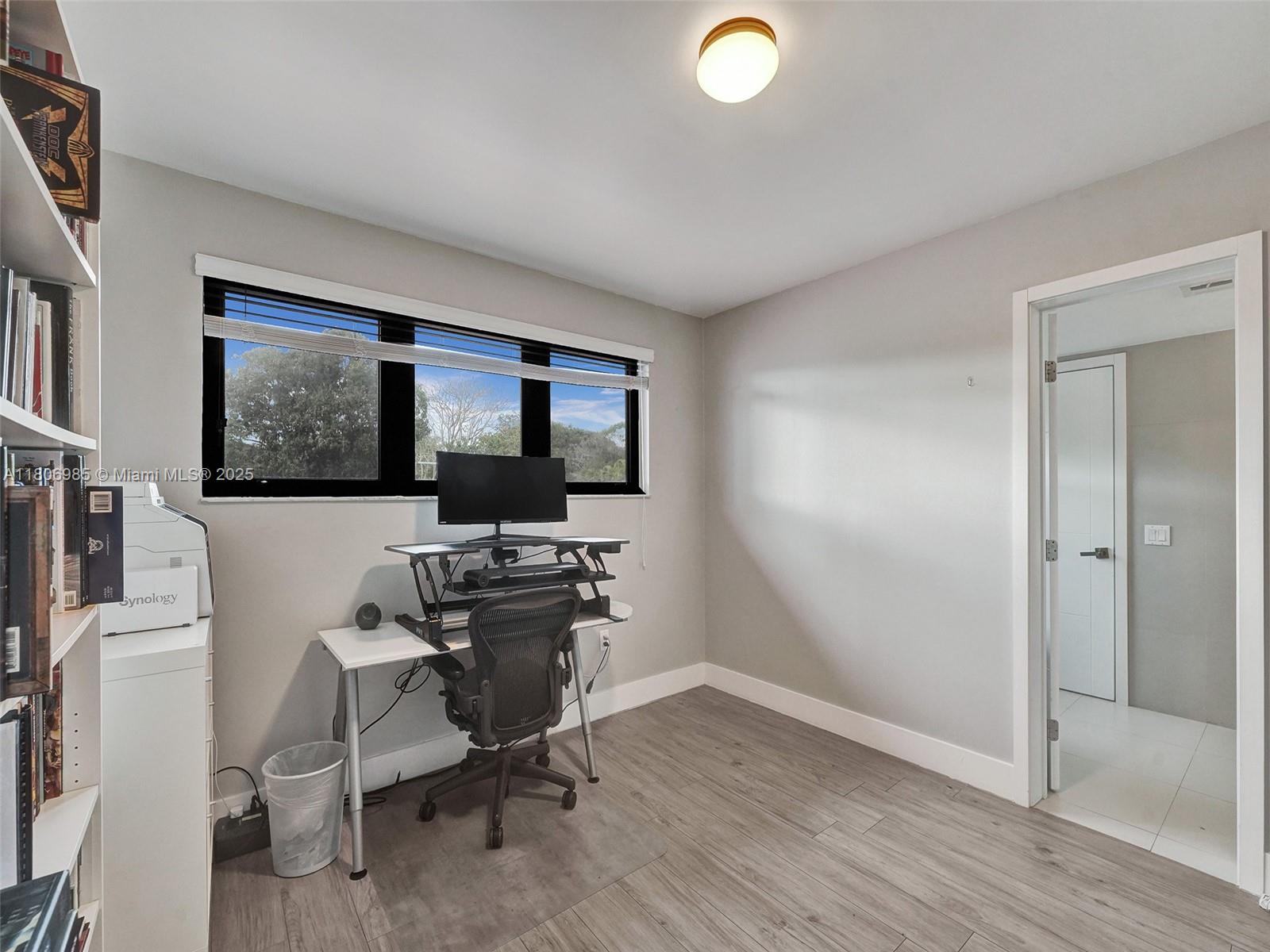 3638 Southwest 57th Avenue Miami, FL 33155 - Photo 25 of 43 a view of a workspace with furniture and a window