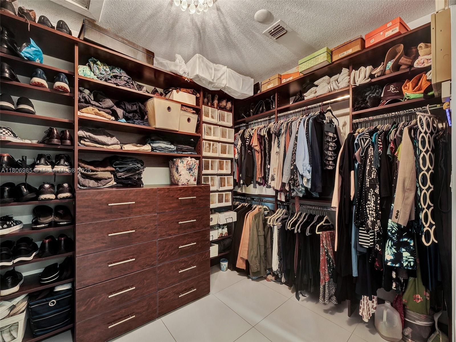 3638 Southwest 57th Avenue Miami, FL 33155 - Photo 28 of 43 a view of walk in closet with clothes and shoes