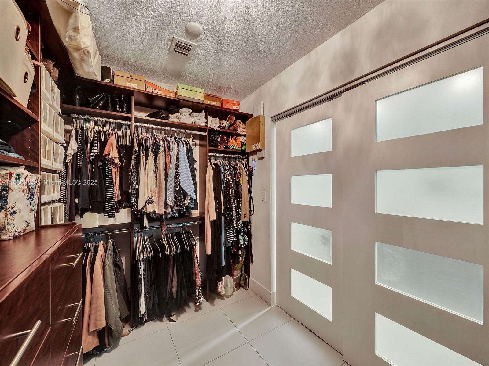 3638 Southwest 57th Avenue Miami, FL 33155 - Photo 29 of 43 a view of walk in closet with clothes and shoes