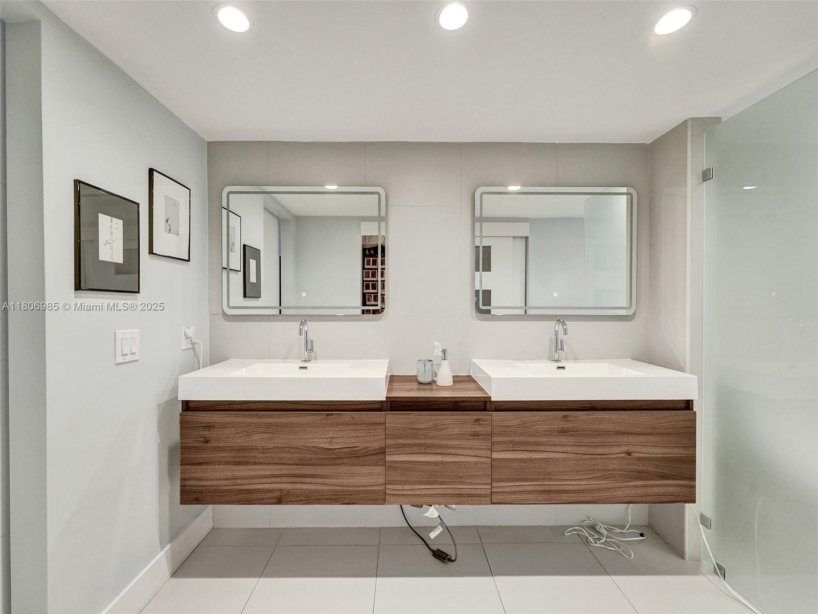 3638 Southwest 57th Avenue Miami, FL 33155 - Photo 30 of 43 a bathroom with double vanity sinks and a mirror