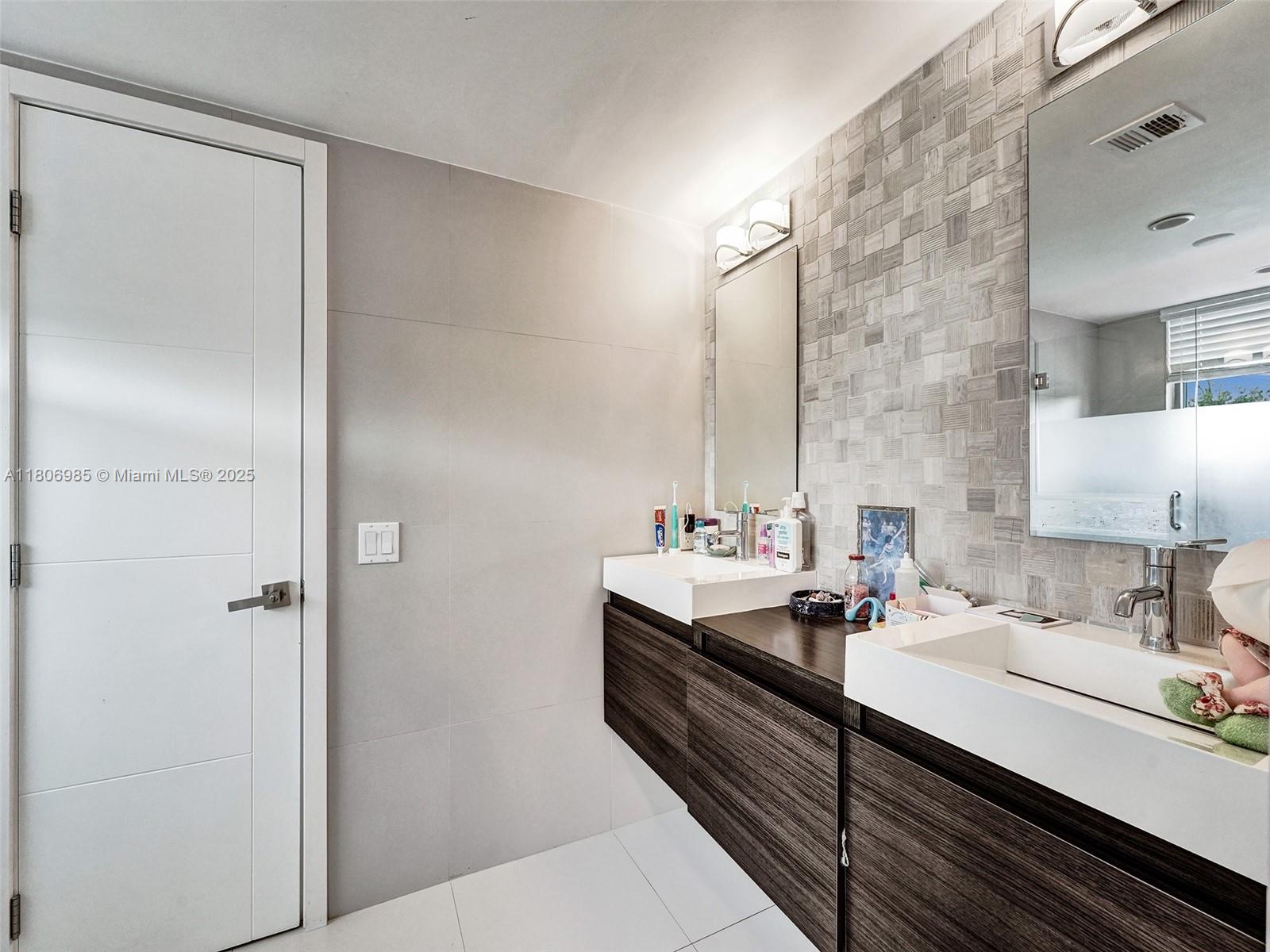 3638 Southwest 57th Avenue Miami, FL 33155 - Photo 31 of 43 a bathroom with a double vanity sink and mirror