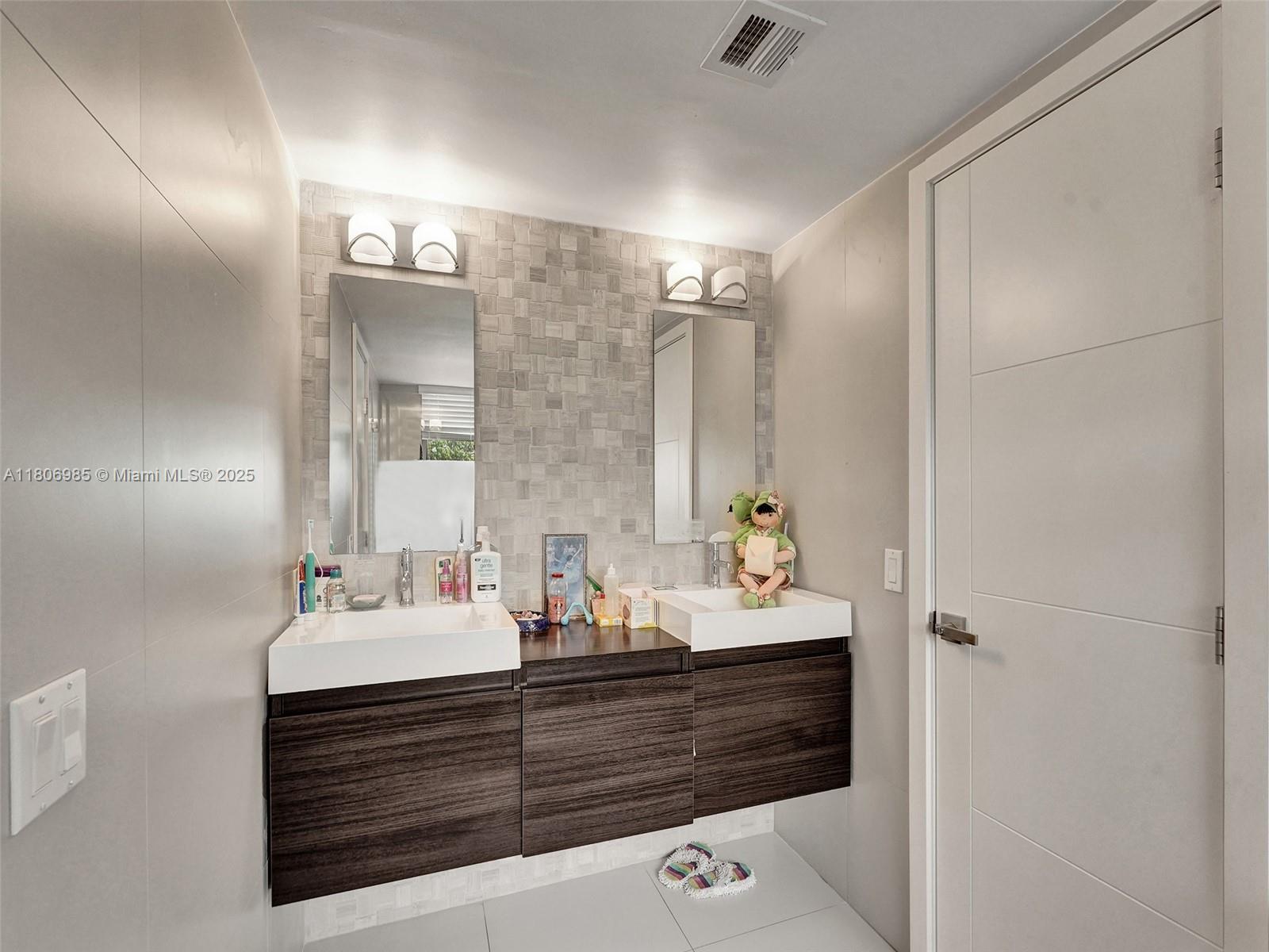 3638 Southwest 57th Avenue Miami, FL 33155 - Photo 32 of 43 a bathroom with a sink double vanity and a mirror