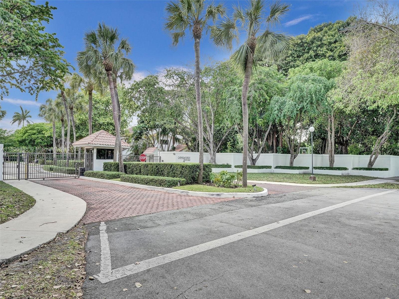 3638 Southwest 57th Avenue Miami, FL 33155 - Photo 42 of 43 a front view of a house with a yard and trees