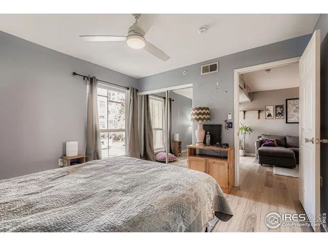 a bedroom with a bed and a large mirror