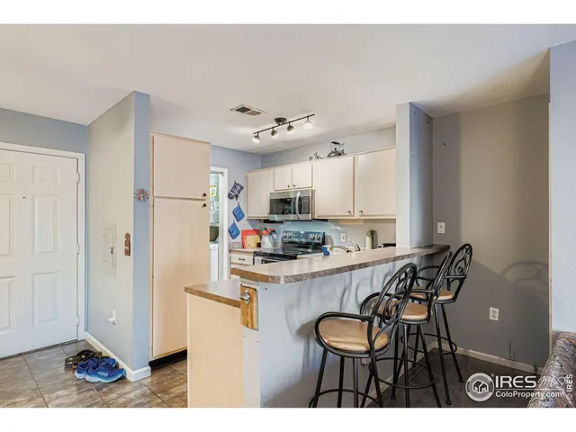 a kitchen with stainless steel appliances a refrigerator and a stove