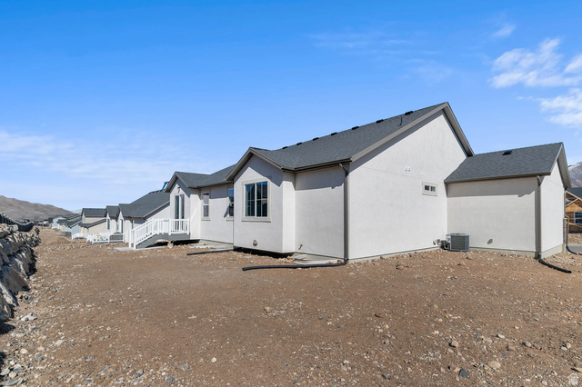 1024 South Tanner Road Santaquin, UT 84655 - Photo 2 of 20 View of side of home with a shingled roof and stucco siding
