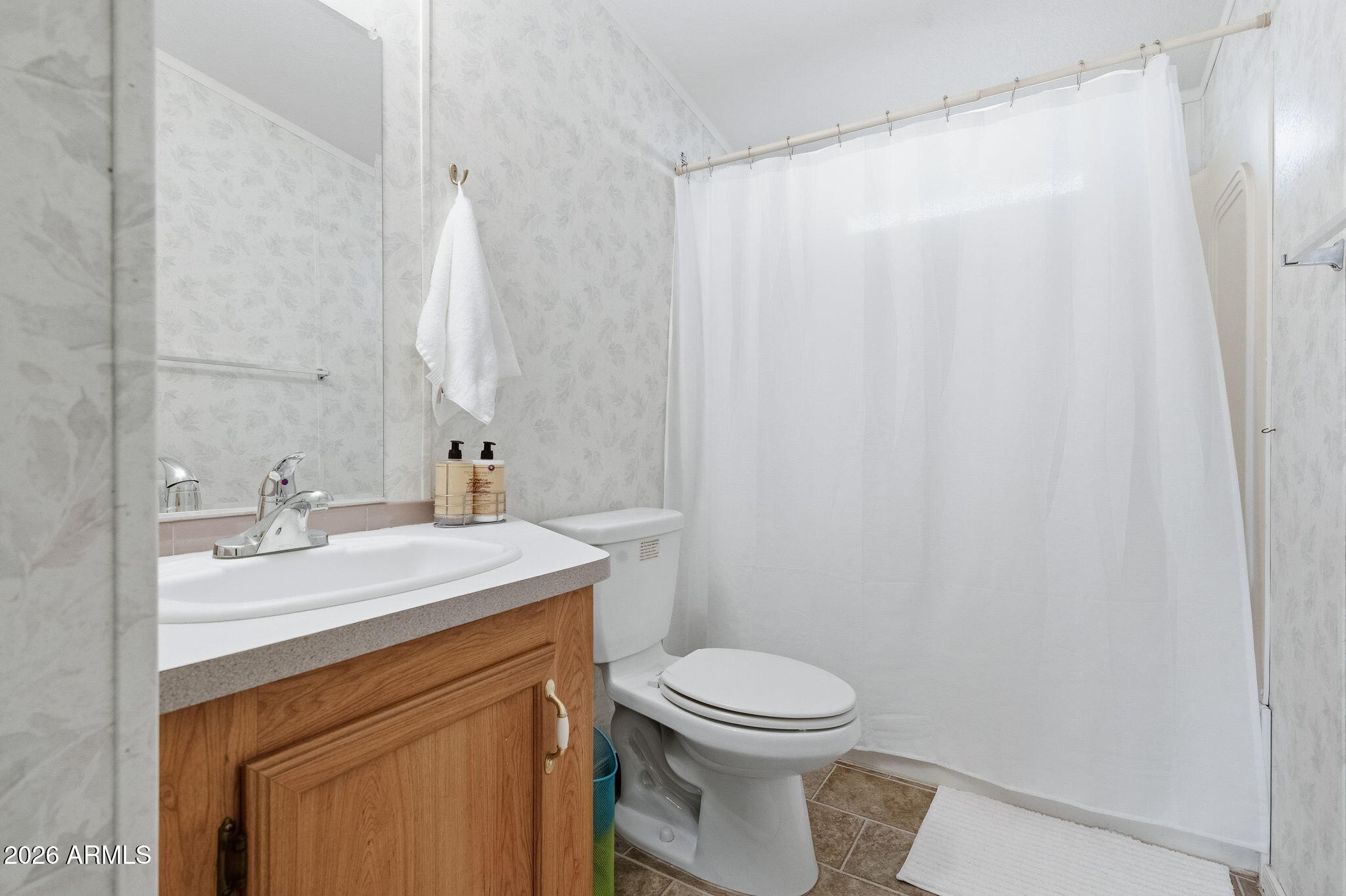 13202 North 19th Way Phoenix, AZ 85022 - Photo 16 of 20 a bathroom with a sink a toilet and vanity