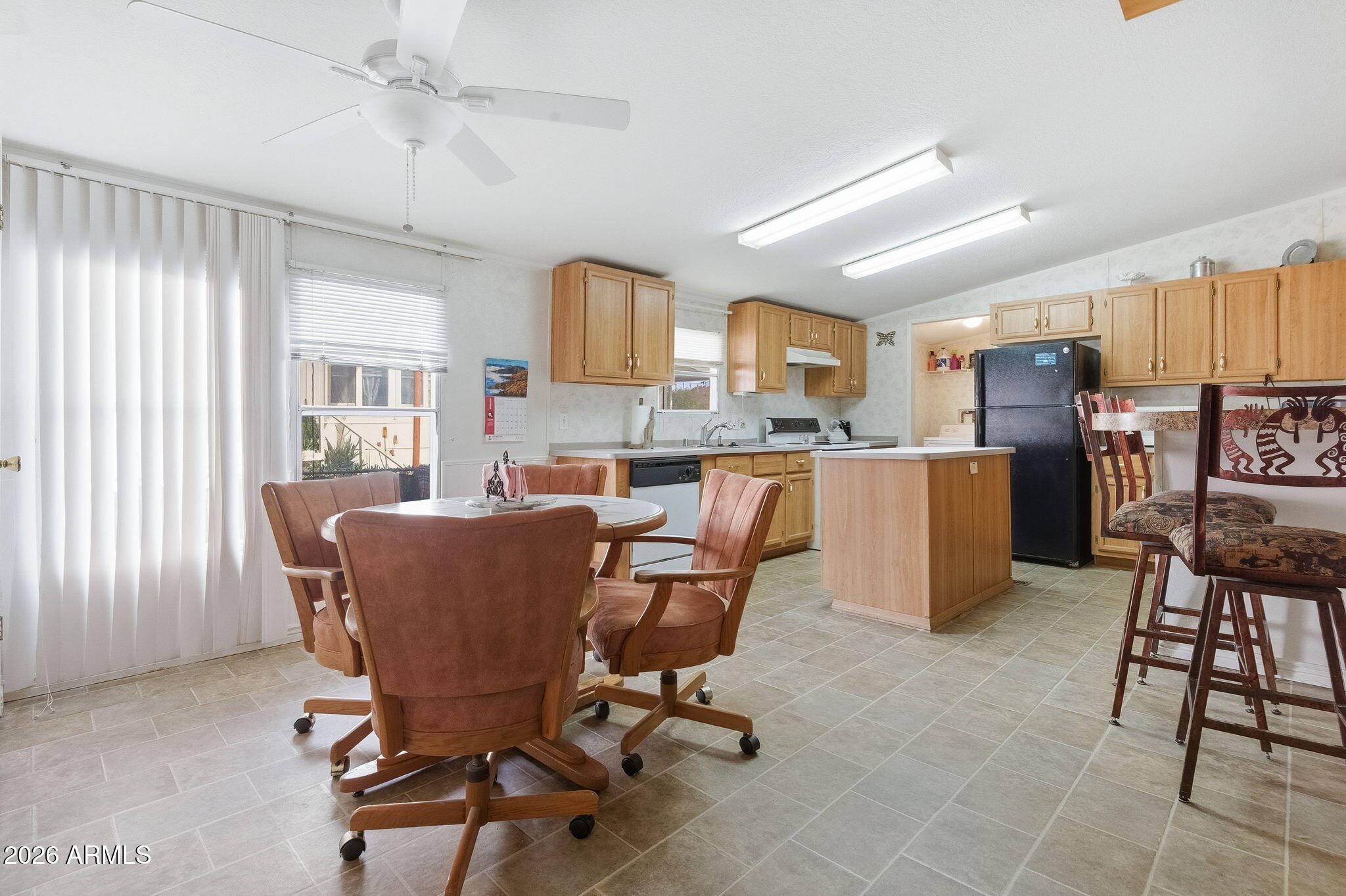 13202 North 19th Way Phoenix, AZ 85022 - Photo 5 of 20 a living room with furniture and a dining table with kitchen appliances