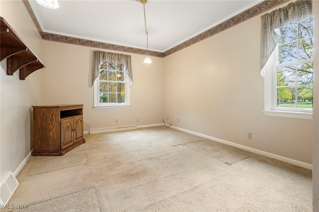 14265 Reeder Avenue Northeast Alliance, OH 44601 - Photo 15 of 39 Unfurnished dining area with ornamental molding, carpet, and baseboard heating
