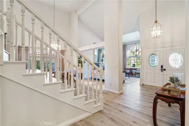 a view of a hallway with wooden floor and entryway