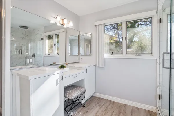 a spacious bathroom with a double vanity sink and a mirror