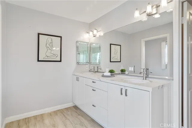 a bed sitting in a spacious bedroom next to a window