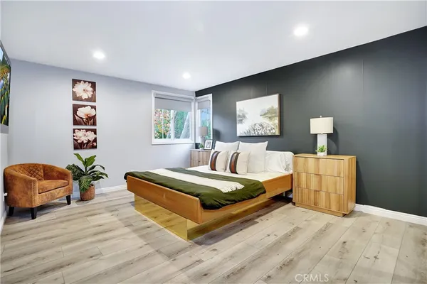 a bedroom with a large bed and a couch