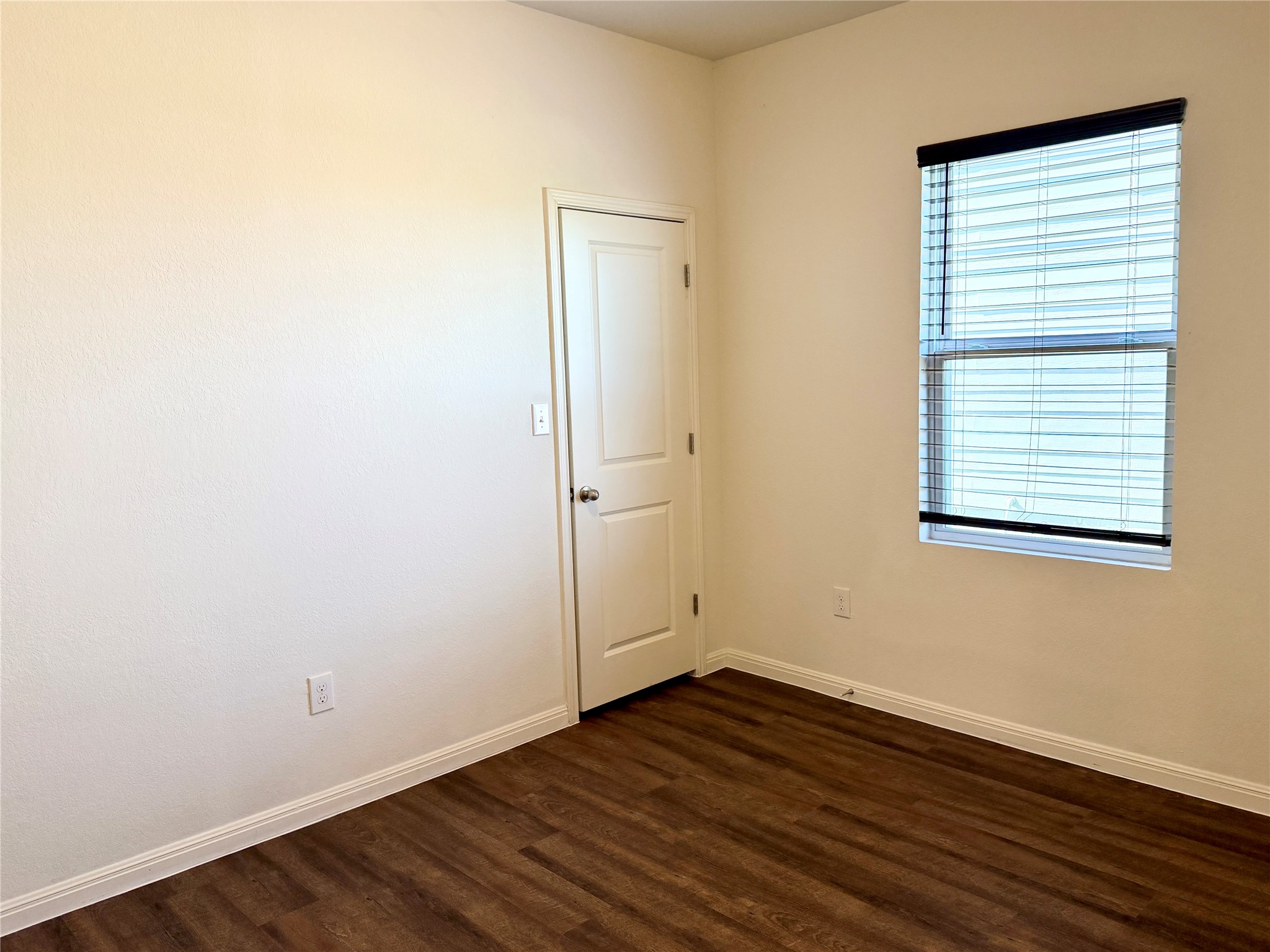 360 Bell Rings Drive Jarrell, TX 76537 - Photo 8 of 10 Rich hardwood floors create a welcoming atmosphere in this adaptable bedroom space.