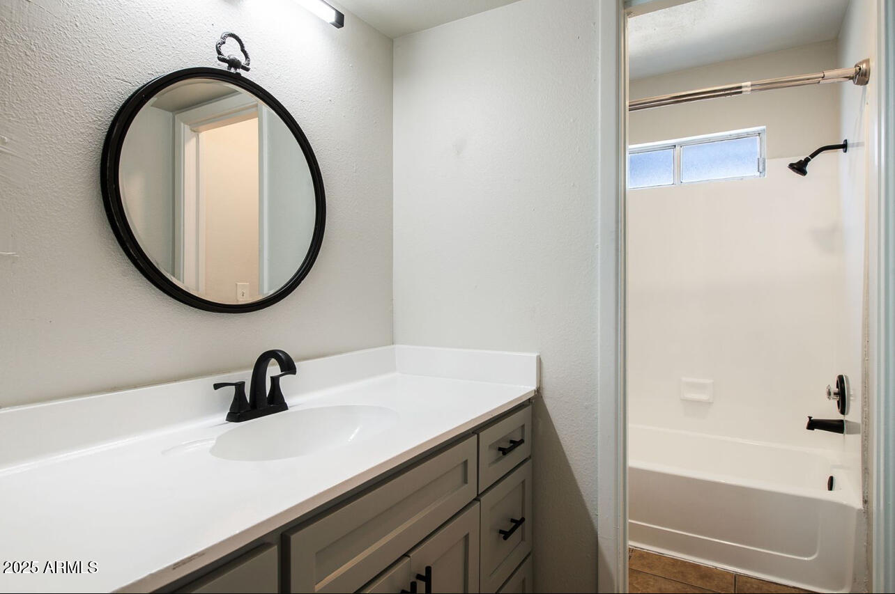 1861 N Spring Mesa, AZ 85203 - Photo 12 of 29 a bathroom with a sink and a mirror