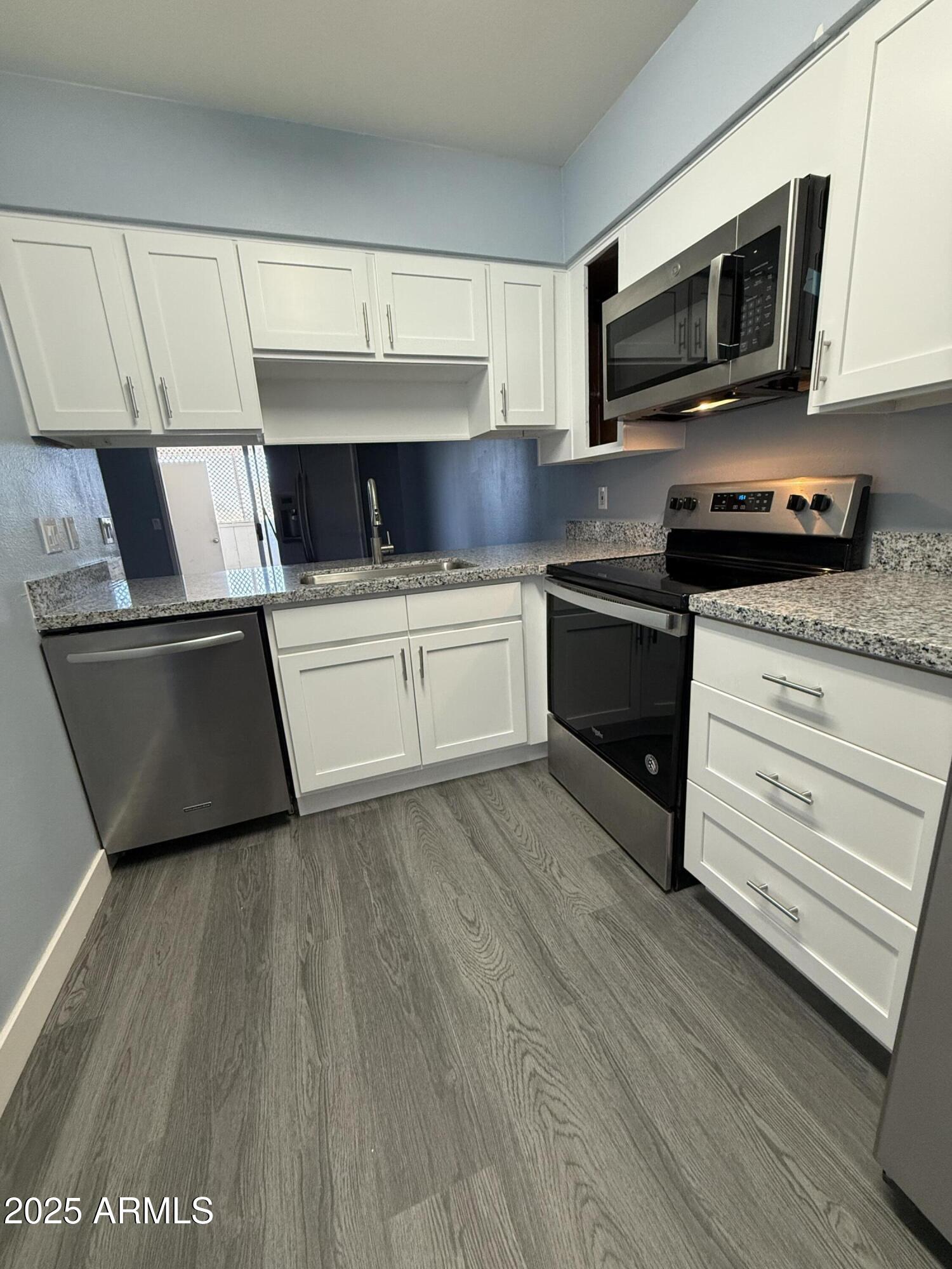 1861 N Spring Mesa, AZ 85203 - Photo 17 of 29 a kitchen with a microwave stove top oven and sink