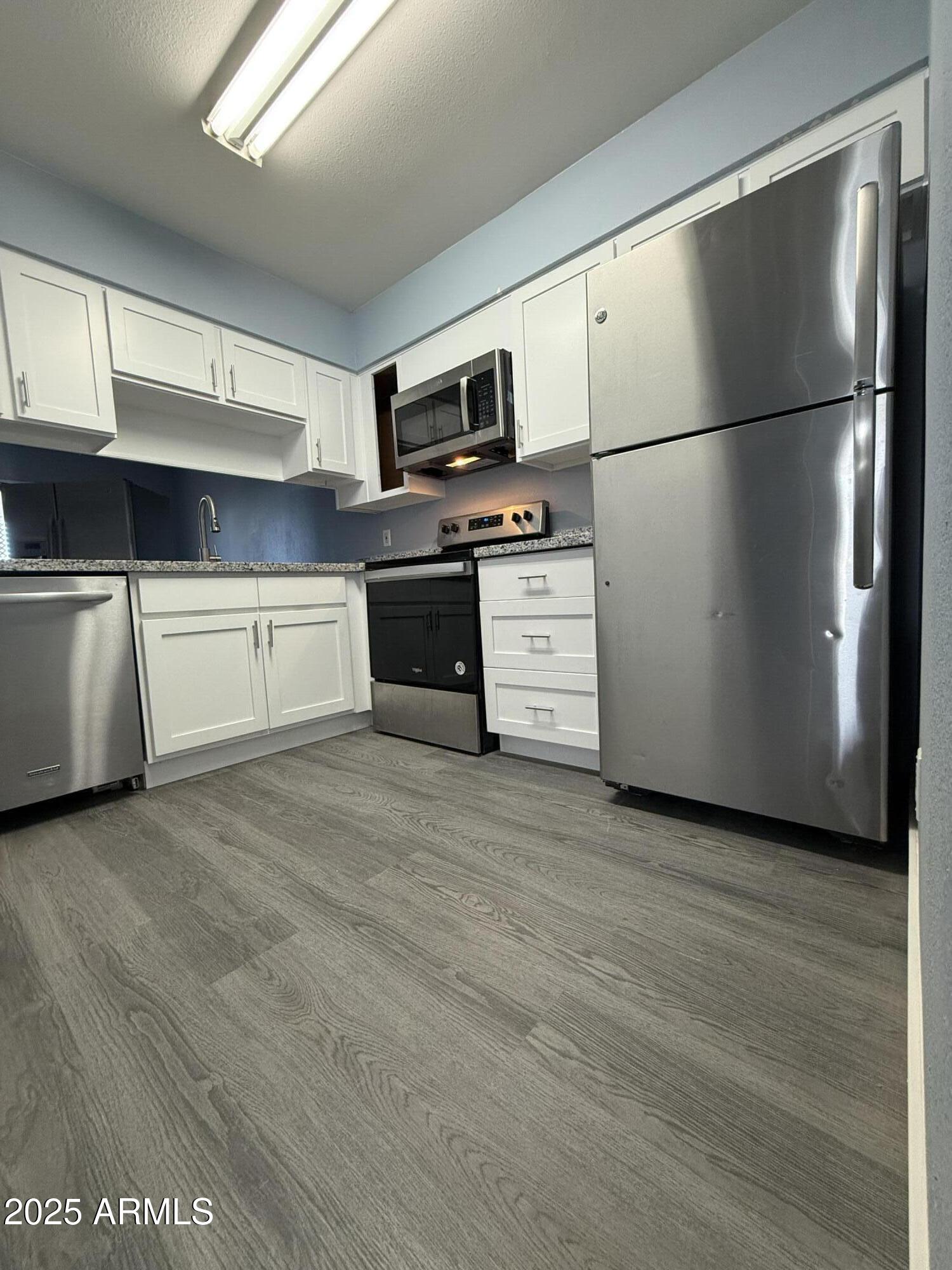 1861 N Spring Mesa, AZ 85203 - Photo 18 of 29 a kitchen with stainless steel appliances a refrigerator stove and microwave