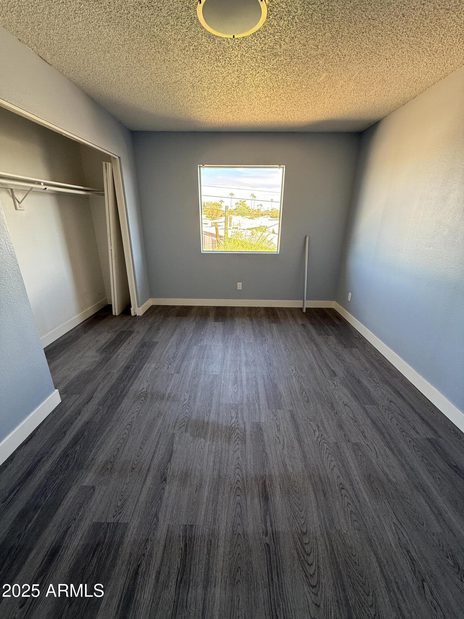 1861 N Spring Mesa, AZ 85203 - Photo 21 of 29 an empty room with wooden floor and windows