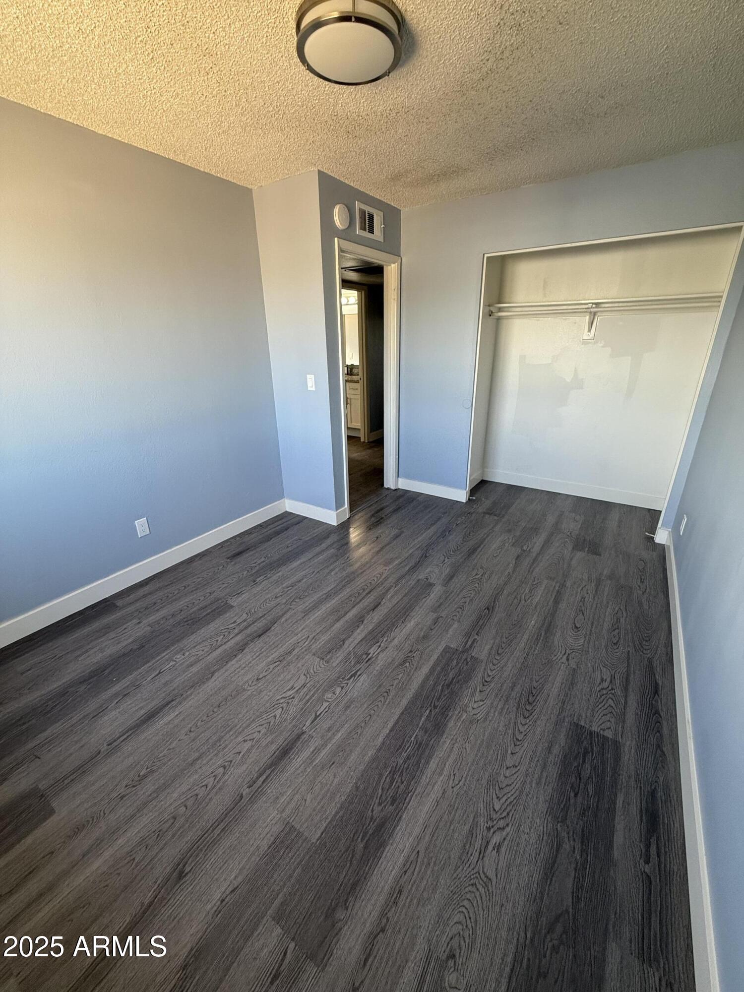 1861 N Spring Mesa, AZ 85203 - Photo 22 of 29 a view of an empty room with wooden floor and a window