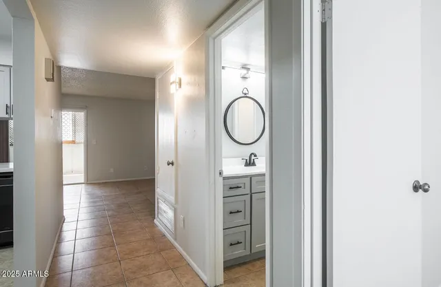 an empty room with fan and windows