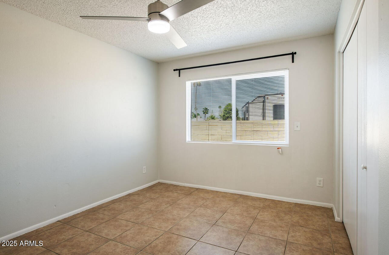 1861 N Spring Mesa, AZ 85203 - Photo 9 of 29 an empty room with a window and a fan
