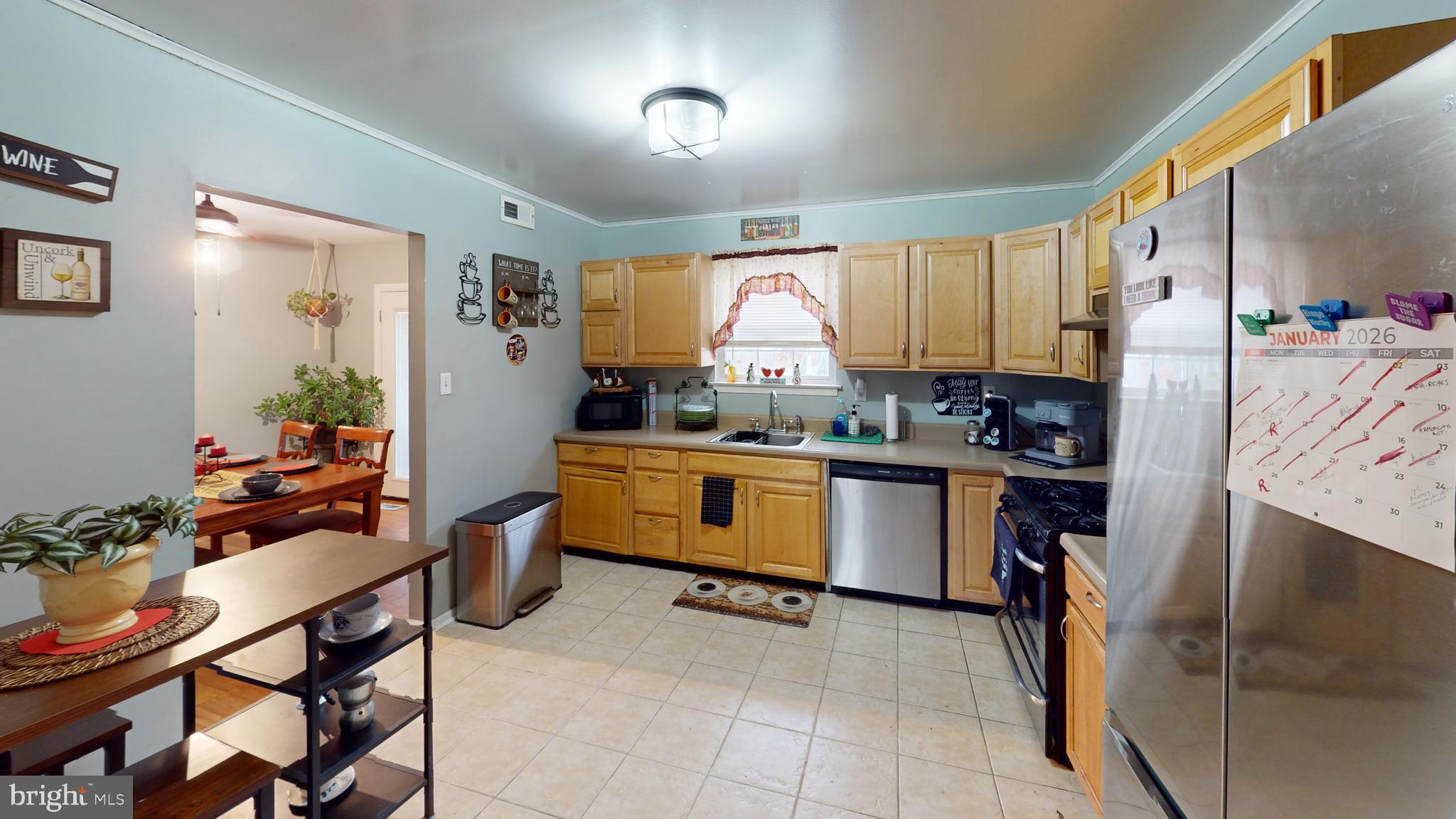 1121 Robin Terrace Millville, NJ 08332 - Photo 13 of 29 a kitchen with stainless steel appliances a stove a sink dishwasher and cabinets with wooden floor