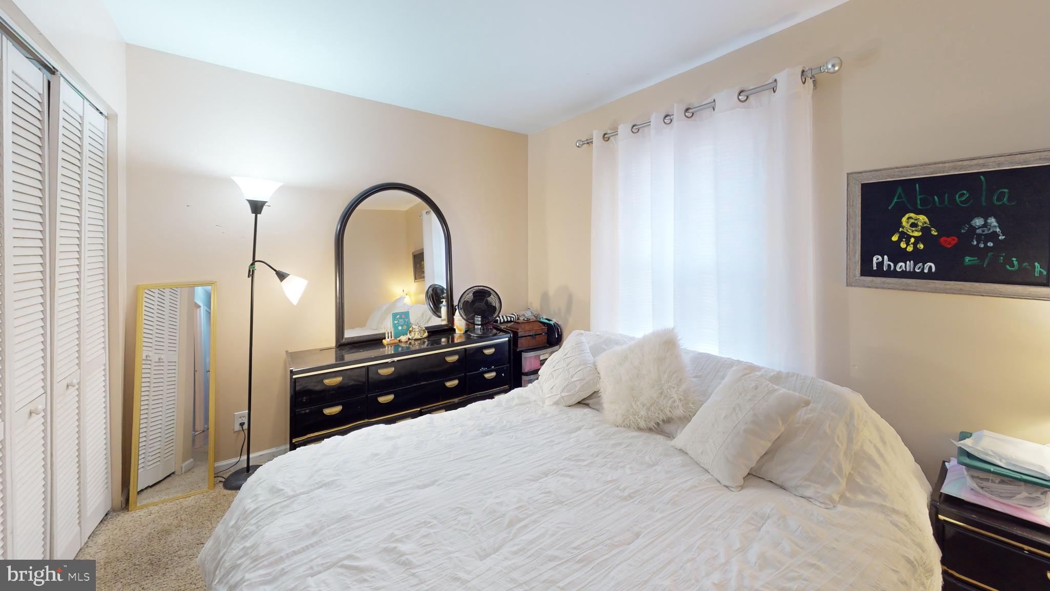 1121 Robin Terrace Millville, NJ 08332 - Photo 18 of 29 a bedroom with a bed and a black countertop with white comforter