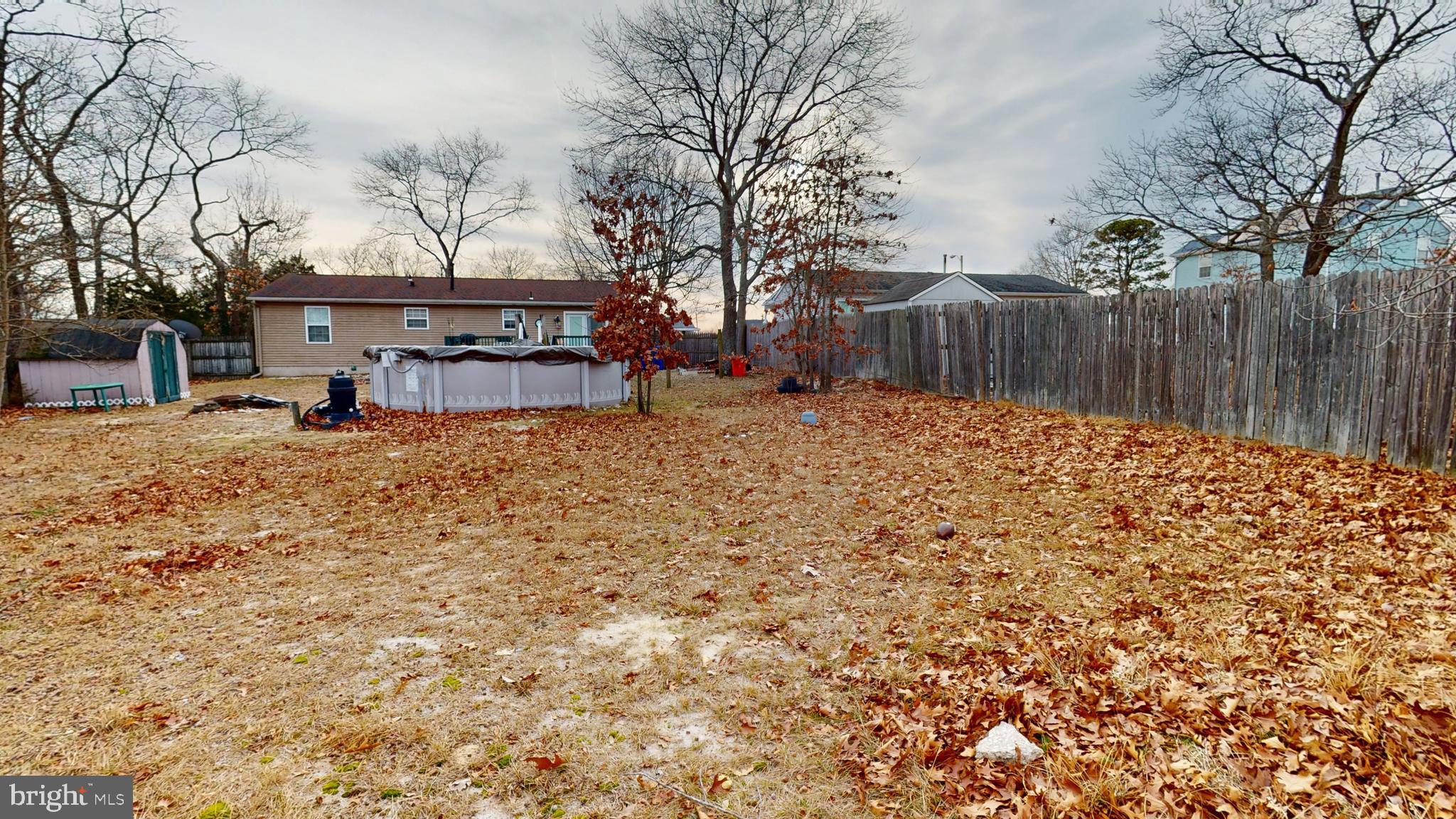 1121 Robin Terrace Millville, NJ 08332 - Photo 29 of 29 a view of a backyard with wooden fence and large trees