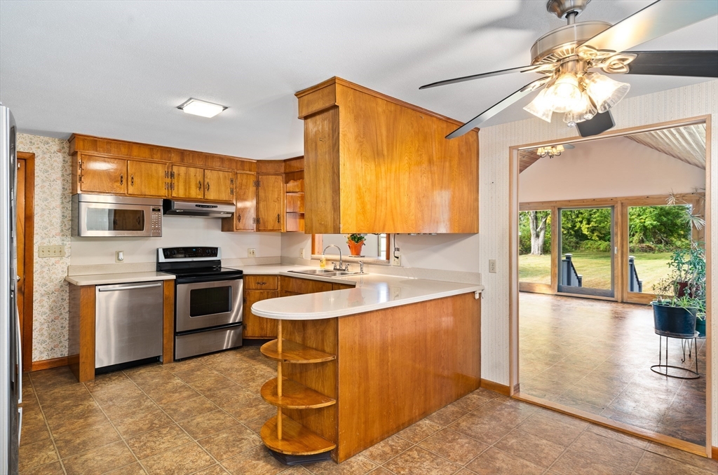 26 Brook Street Easthampton, MA 01027 - Photo 12 of 27 a kitchen with stainless steel appliances granite countertop a sink a stove and refrigerator