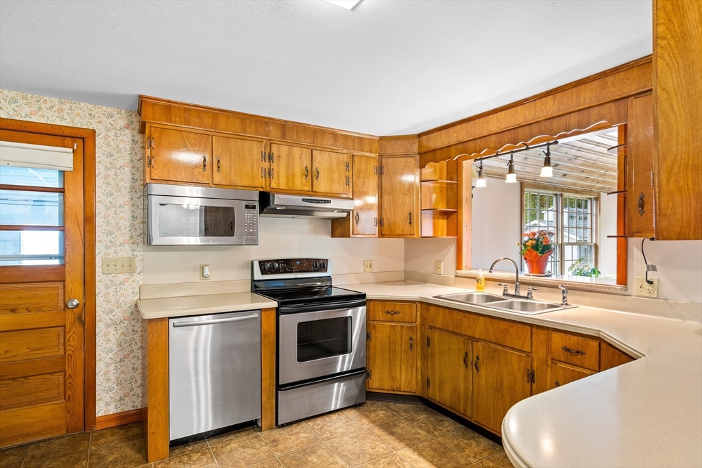26 Brook Street Easthampton, MA 01027 - Photo 13 of 27 a kitchen with stainless steel appliances a stove a sink and a refrigerator