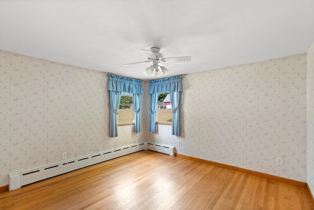26 Brook Street Easthampton, MA 01027 - Photo 18 of 27 an empty room with a window and a ceiling fan