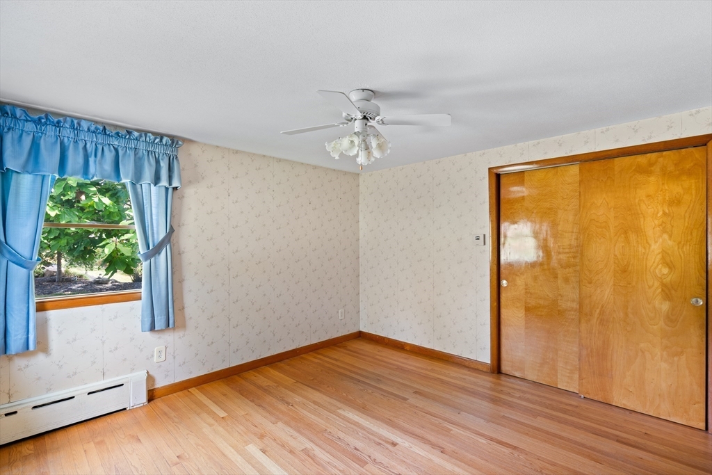 26 Brook Street Easthampton, MA 01027 - Photo 19 of 27 a view of an empty room with a window and wooden floor