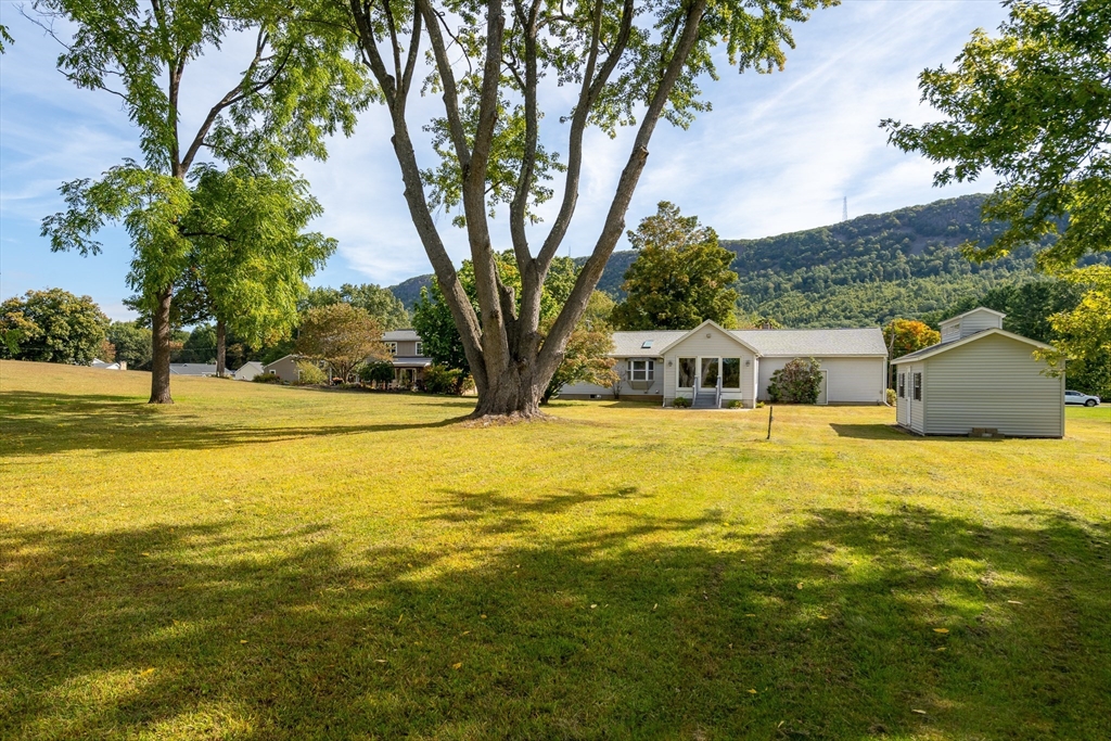 26 Brook Street Easthampton, MA 01027 - Photo 5 of 27 a house view with swimming pool in front of it