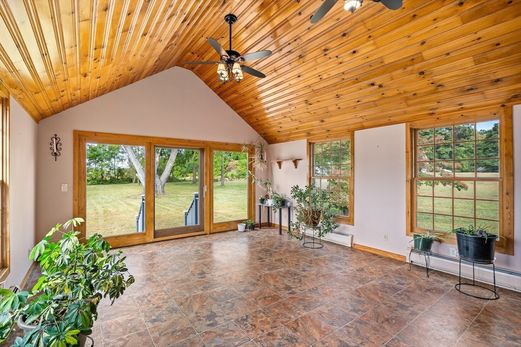 26 Brook Street Easthampton, MA 01027 - Photo 9 of 27 a porch with a table and chairs under an umbrella