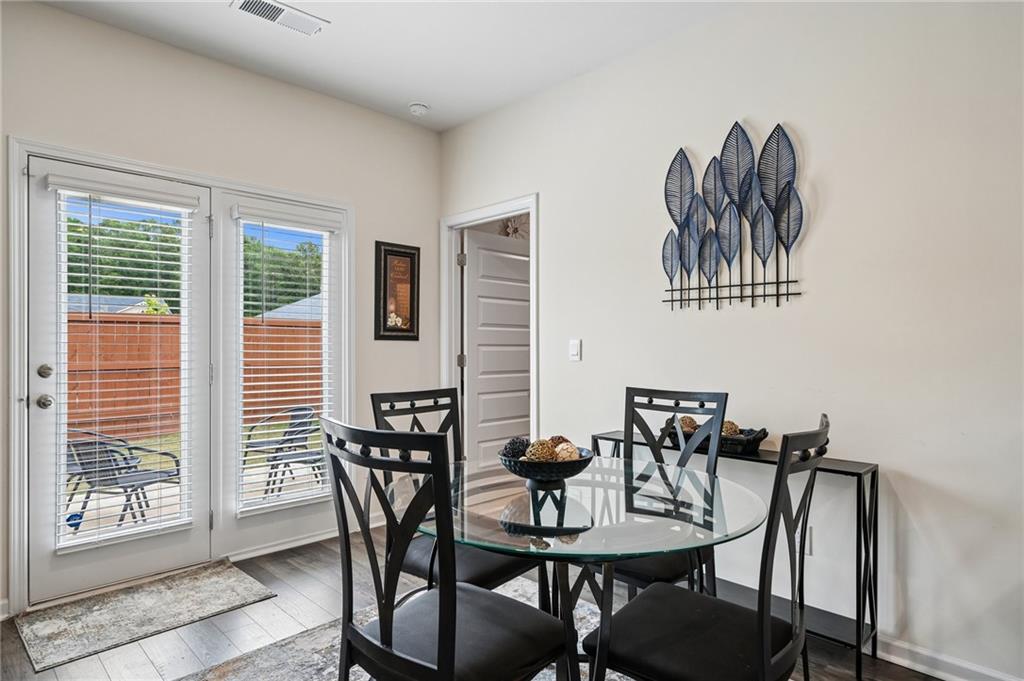 8592 Seabiscuit Road Lithonia, GA 30058 - Photo 4 of 25 a view of a dining room with furniture and wooden floor
