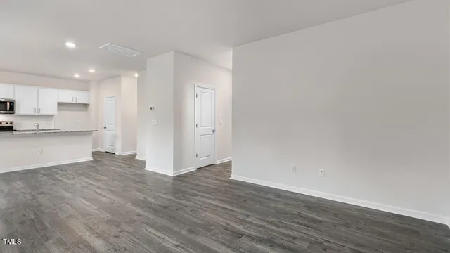 a view of a kitchen with wooden floor and a sink