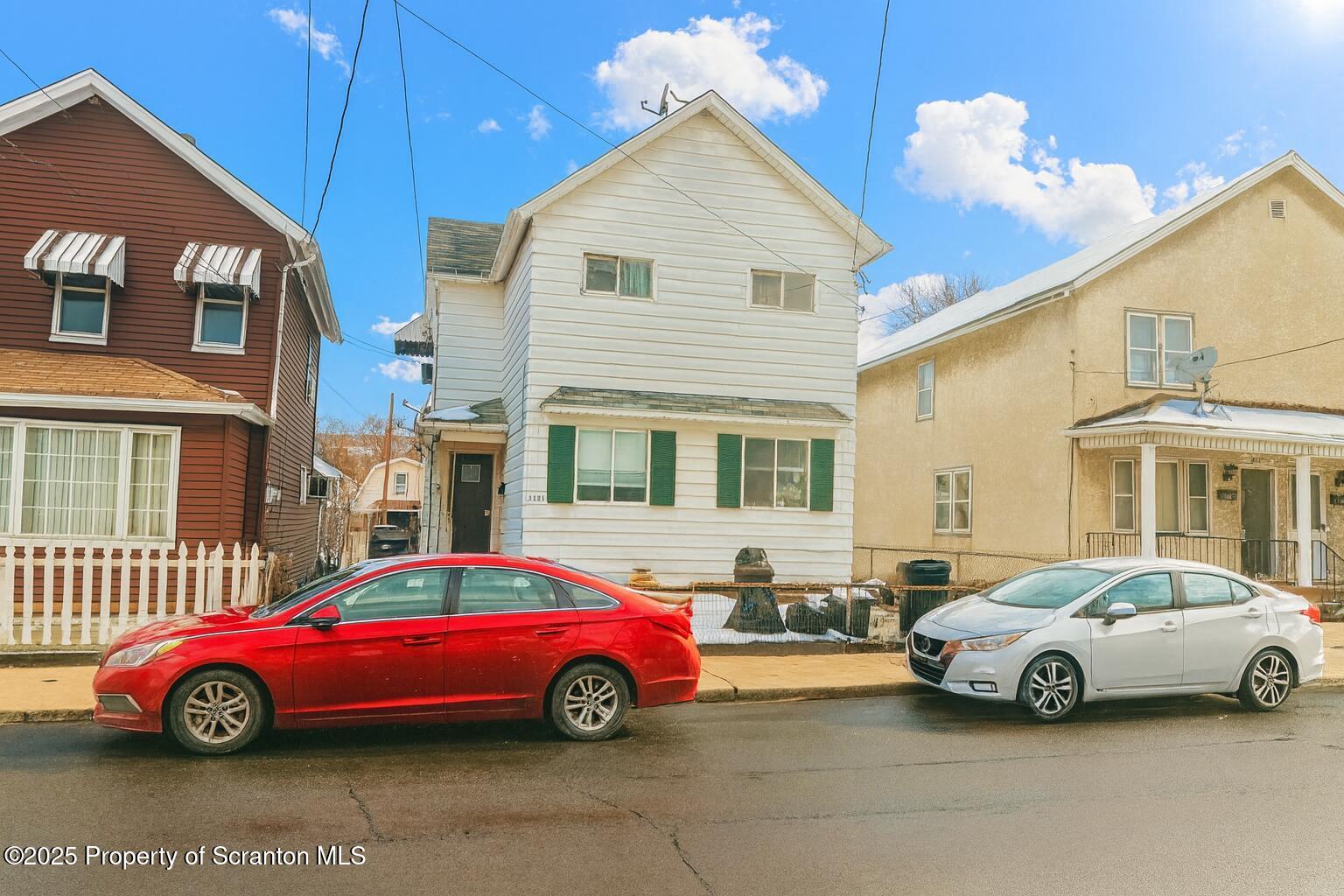 a cars parked in front of a house