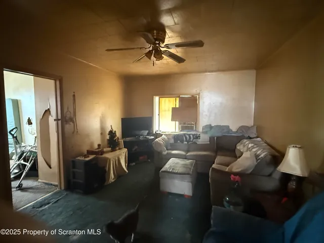 a living room with furniture and a chandelier