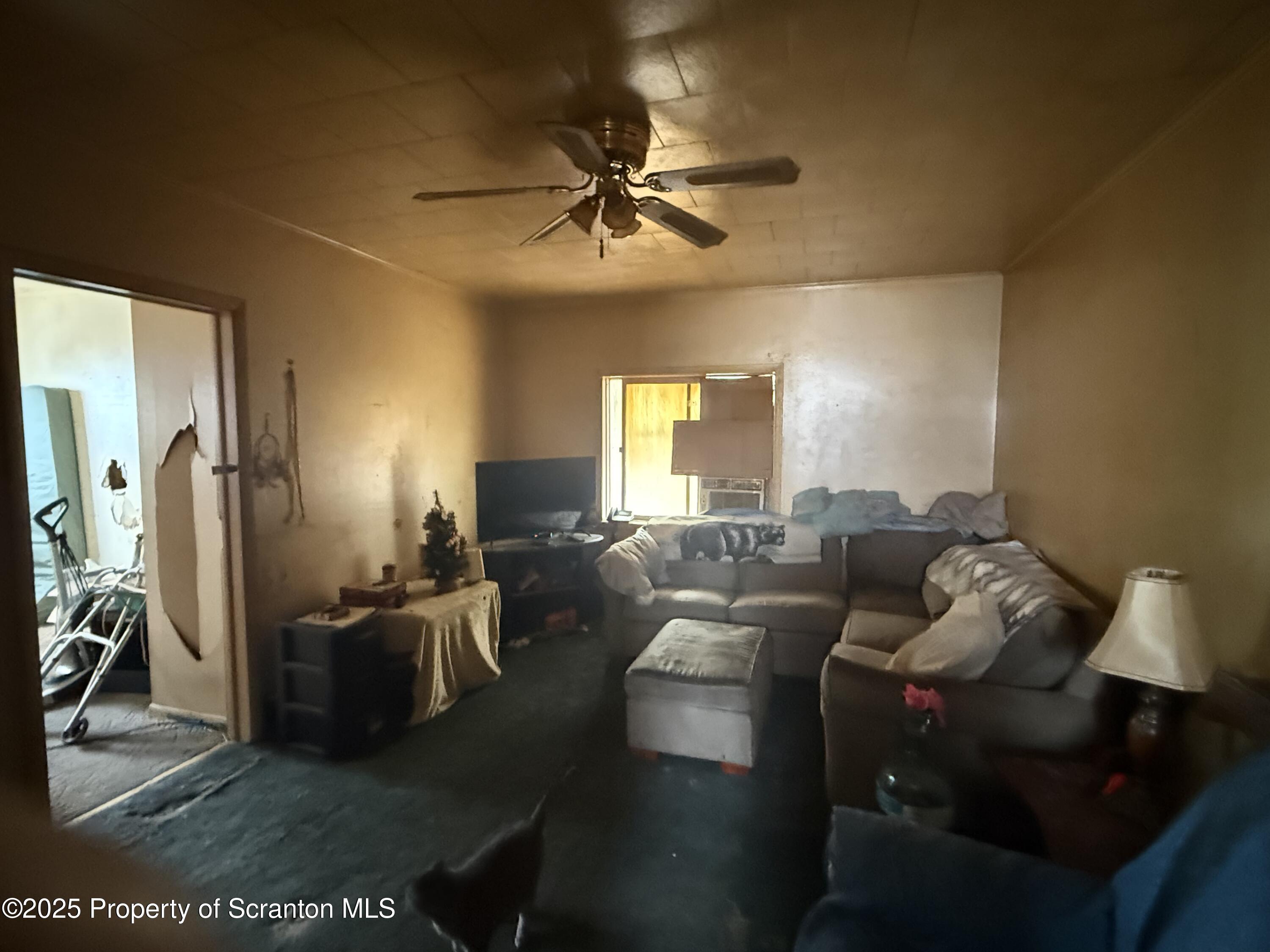1121 Albright Avenue Scranton, PA 18508 - Photo 15 of 17 a living room with furniture and a chandelier