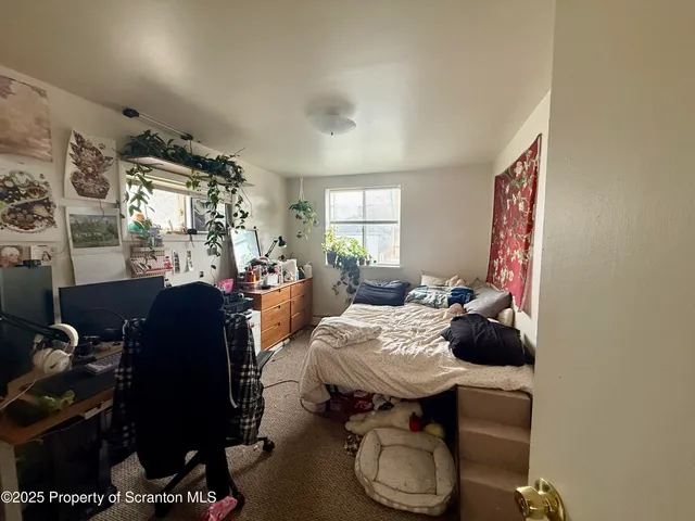 a living room with furniture a rug and a window