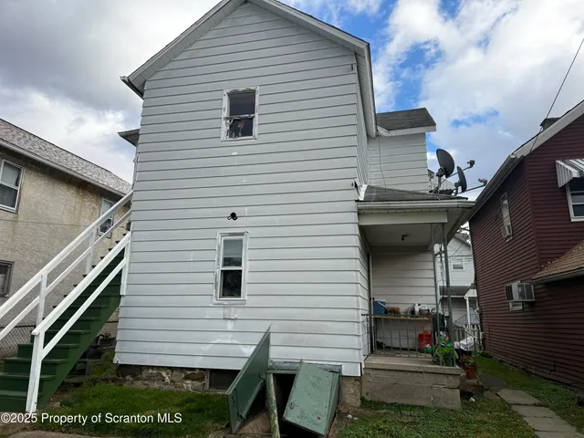 a view of house with backyard and a patio