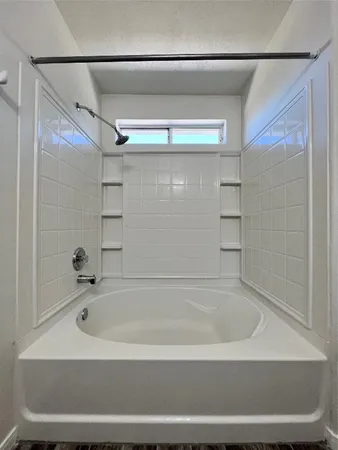 a bathroom with a bathtub and shower