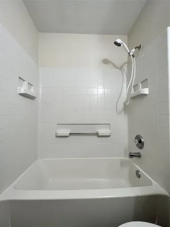 a bathroom with a bath tub and a shower