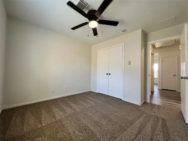 an empty room with closet area